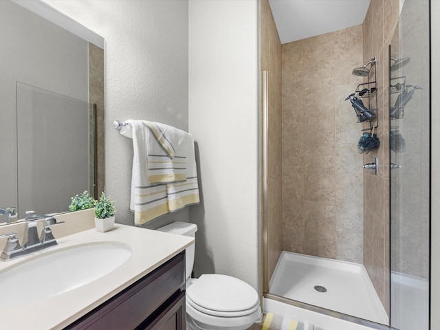 bathroom with vanity, toilet, and an enclosed shower