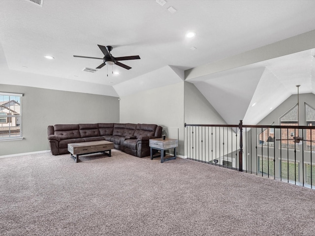 carpeted living room with ceiling fan and lofted ceiling