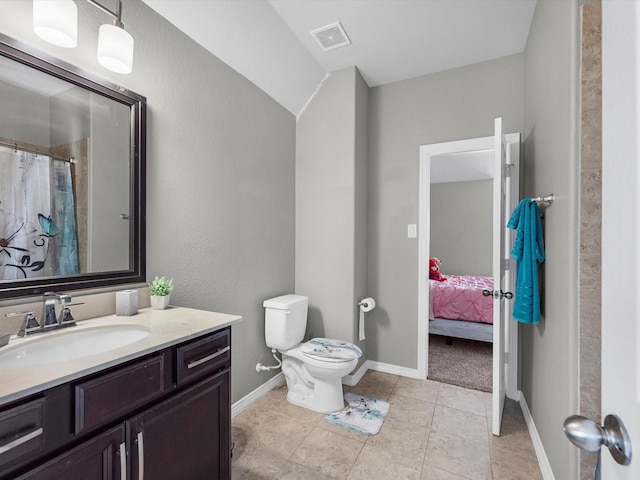 bathroom featuring tile patterned floors, vanity, and toilet