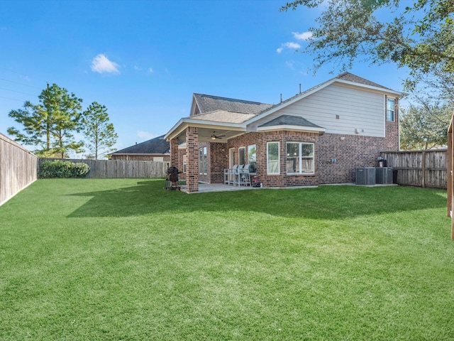 rear view of property with a lawn, ceiling fan, and a patio