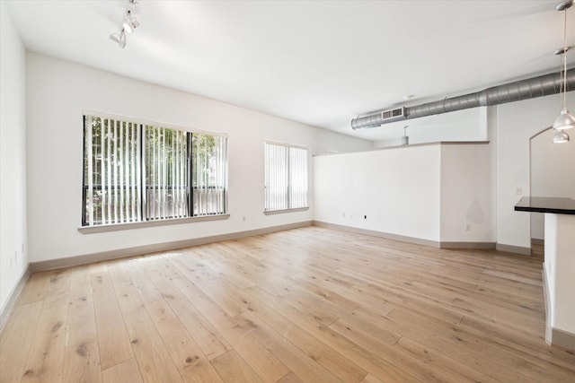 unfurnished living room with light hardwood / wood-style floors