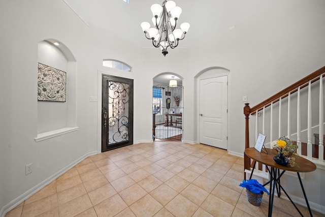 foyer entrance with a chandelier and light tile patterned flooring