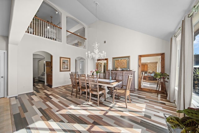 dining room with a towering ceiling and a notable chandelier