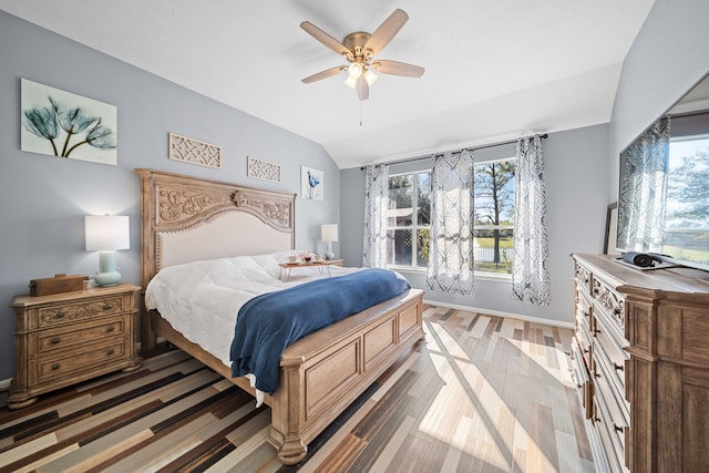 bedroom with hardwood / wood-style floors, ceiling fan, and lofted ceiling