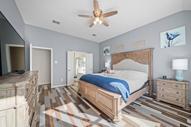 bedroom featuring ceiling fan, dark hardwood / wood-style floors, lofted ceiling, and ensuite bath