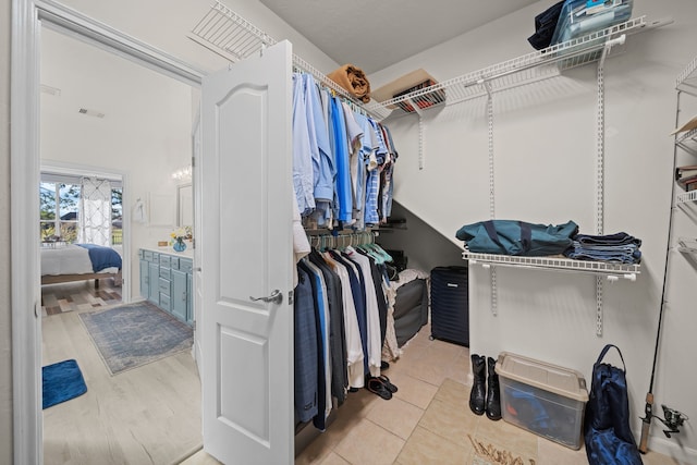 walk in closet featuring light tile patterned floors