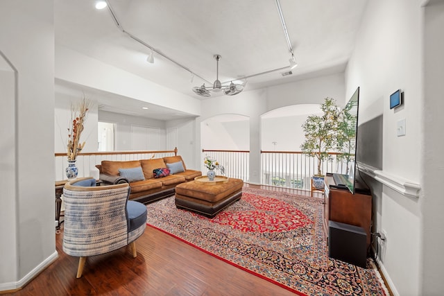 living room featuring ceiling fan, wood-type flooring, and track lighting