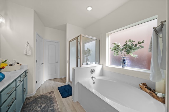 bathroom featuring shower with separate bathtub, vanity, and hardwood / wood-style flooring