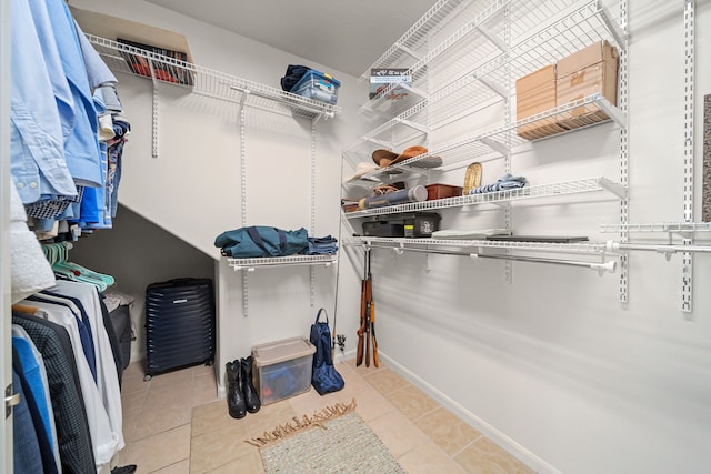 walk in closet with light tile patterned flooring