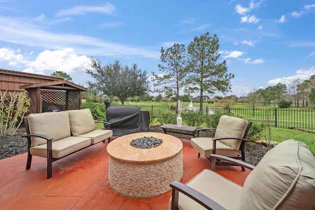 view of patio / terrace with grilling area and an outdoor living space with a fire pit