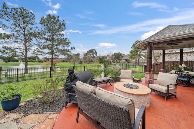 view of patio / terrace featuring a fire pit, a grill, and a water view