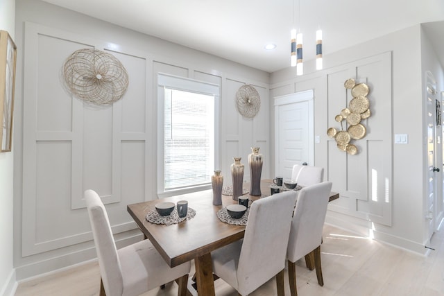 dining area featuring a chandelier and light hardwood / wood-style floors