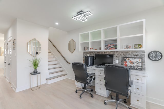 home office with light hardwood / wood-style floors