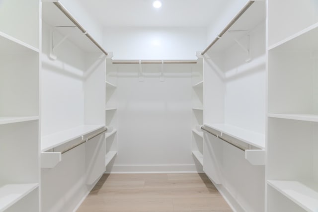 walk in closet featuring light hardwood / wood-style floors