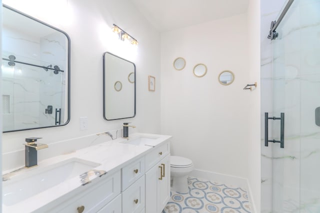 bathroom with vanity, a shower with shower door, and toilet