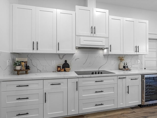 kitchen with white cabinetry, wine cooler, decorative backsplash, and black electric cooktop