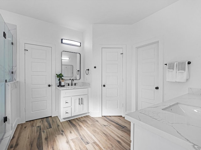 bathroom featuring hardwood / wood-style floors, vanity, and an enclosed shower