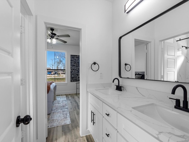 bathroom featuring hardwood / wood-style flooring, ceiling fan, and vanity