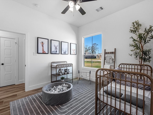 bedroom with ceiling fan and dark wood-type flooring