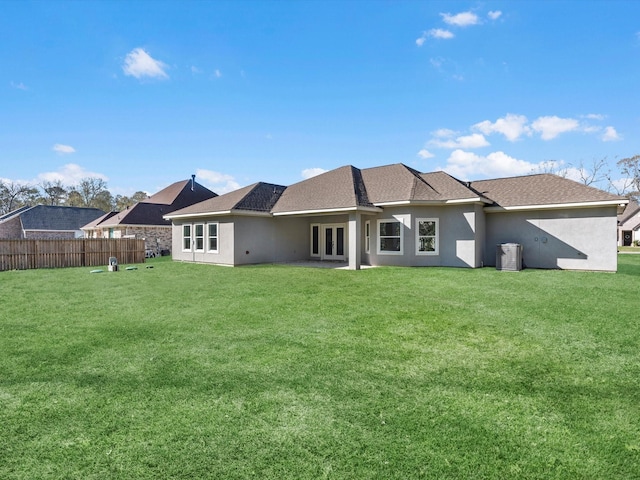 rear view of house featuring a yard and cooling unit