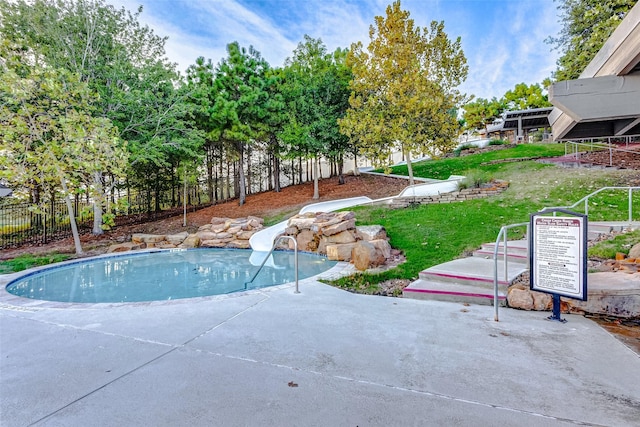 view of pool featuring a yard and a water slide