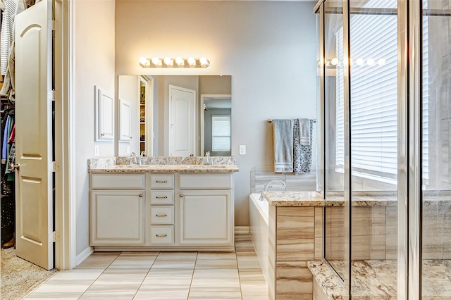 bathroom featuring separate shower and tub, tile patterned flooring, and vanity