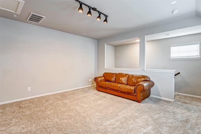 living area featuring light colored carpet and track lighting