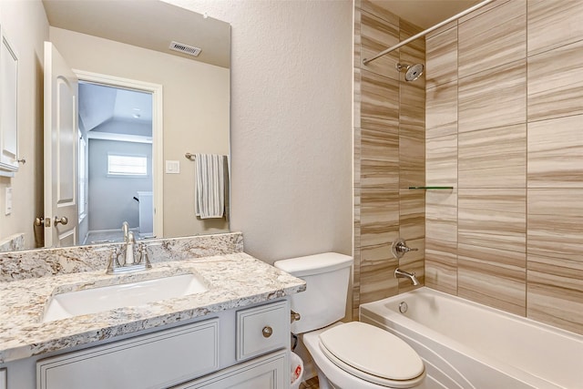 full bathroom featuring vanity, toilet, and tiled shower / bath combo