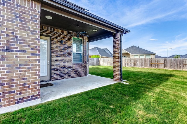 view of yard with a patio area and ceiling fan