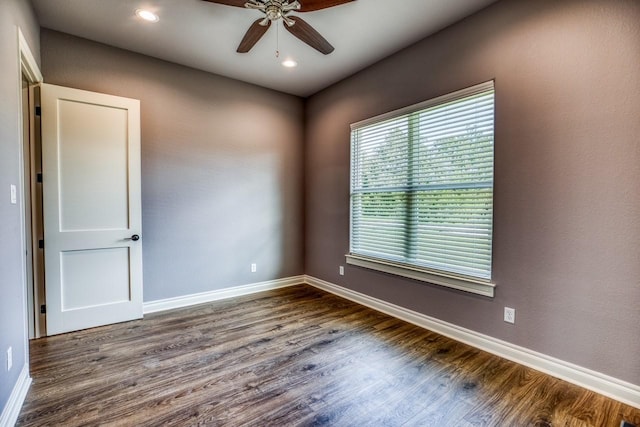 empty room with ceiling fan and wood-type flooring