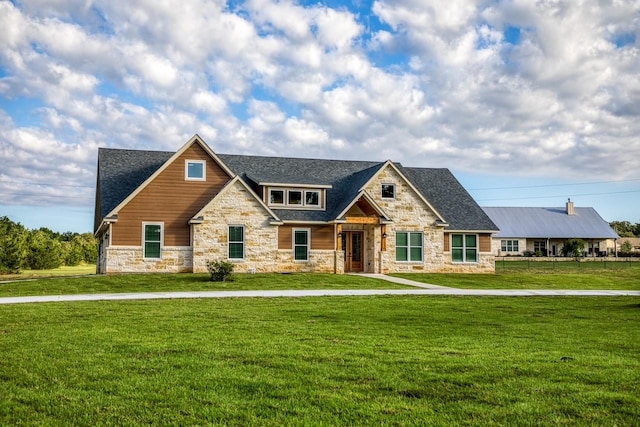 craftsman house with a front lawn, stone siding, and a shingled roof