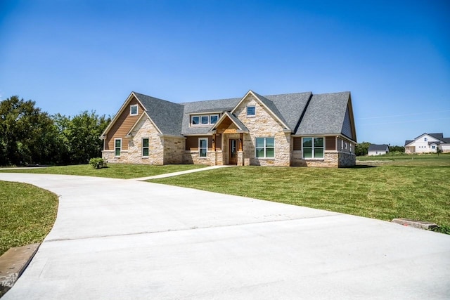 craftsman inspired home featuring a front yard and stone siding