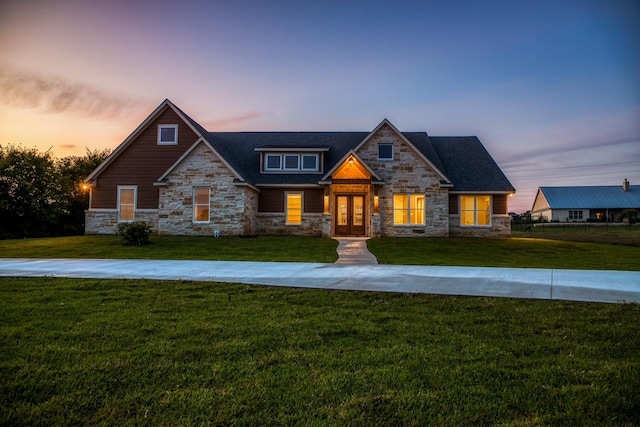 craftsman house featuring a yard and french doors