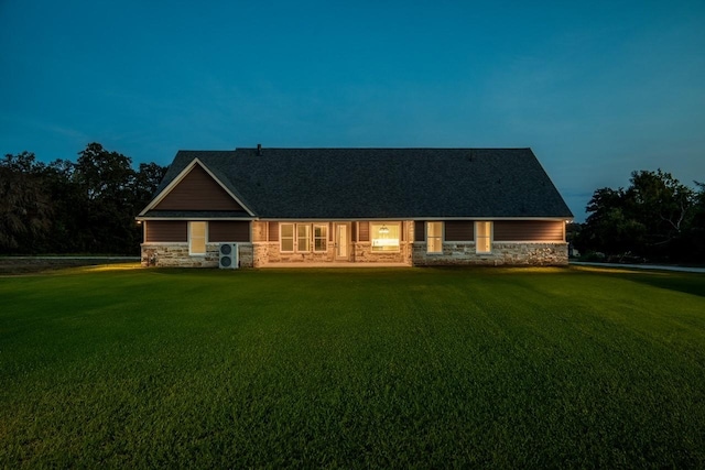 view of front facade featuring a lawn and ac unit