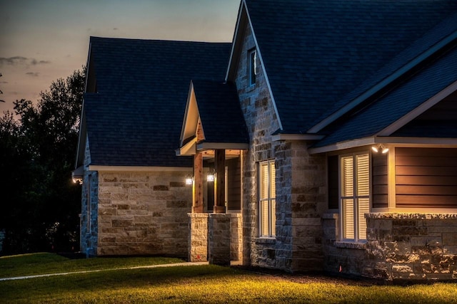 property exterior at dusk with a yard