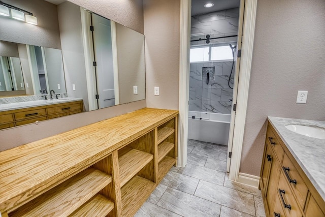 bathroom with vanity and tiled shower / bath combo