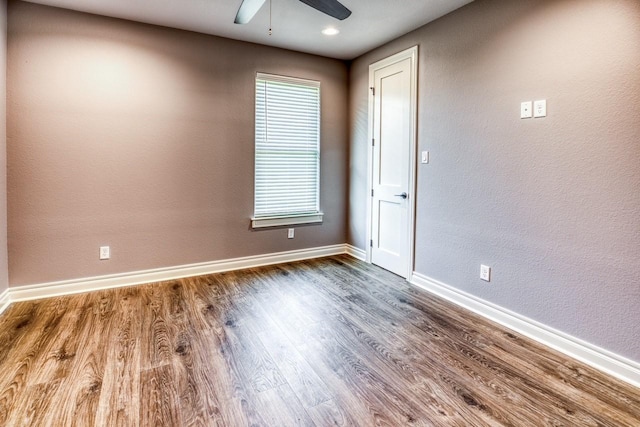 empty room featuring hardwood / wood-style flooring and ceiling fan