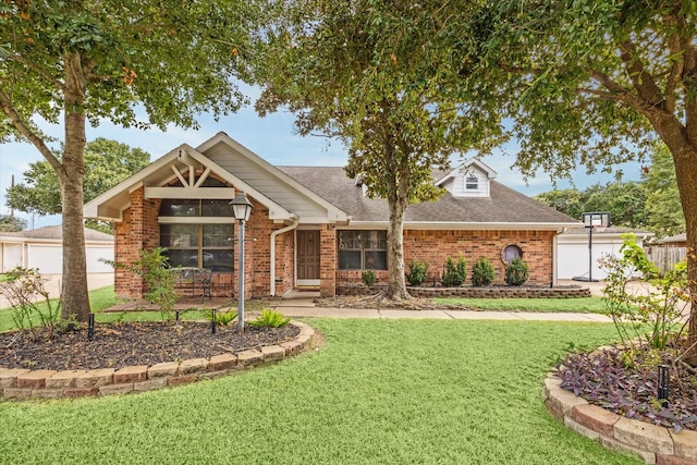 view of front of house with a front yard and a garage