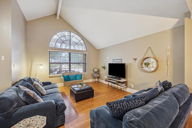 living room featuring lofted ceiling with beams and hardwood / wood-style flooring