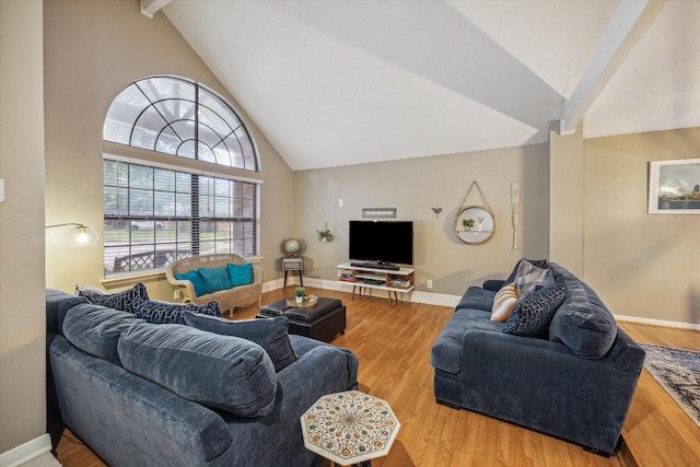 living room with wood-type flooring and vaulted ceiling with beams