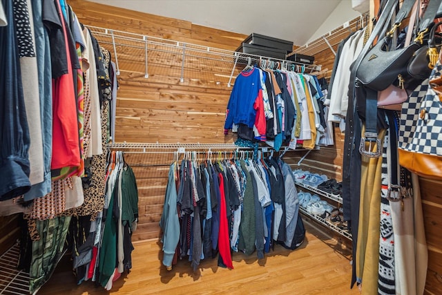 spacious closet featuring hardwood / wood-style flooring and vaulted ceiling