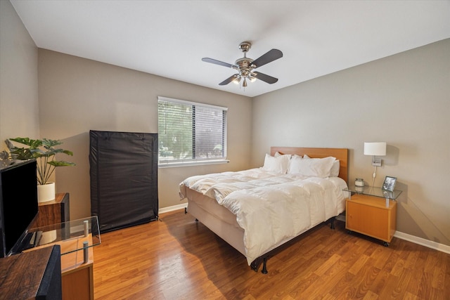 bedroom with ceiling fan and hardwood / wood-style floors