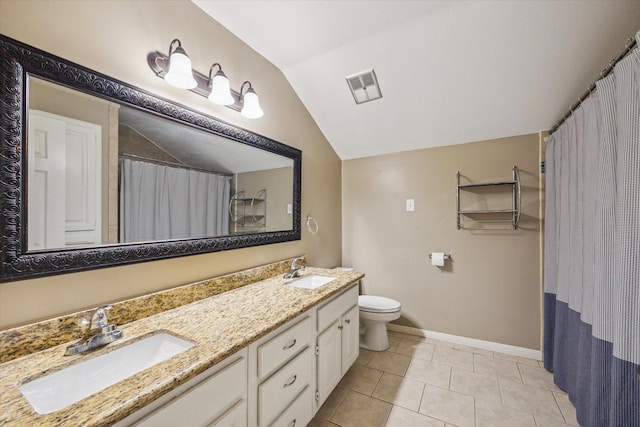 bathroom with tile patterned flooring, vanity, toilet, and vaulted ceiling