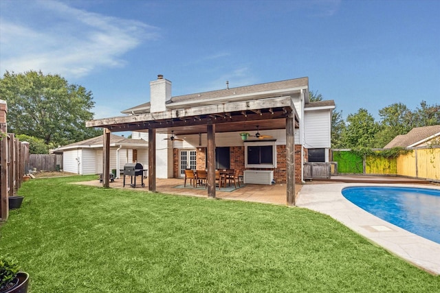 back of house with a fenced in pool, a patio area, ceiling fan, and a yard