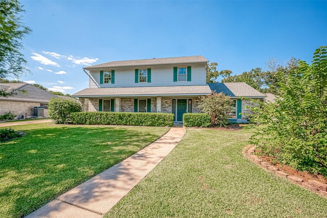 traditional home with brick siding and a front lawn