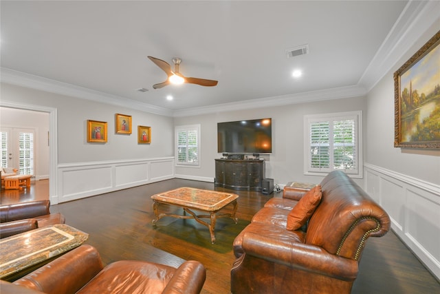 living room featuring dark wood-type flooring, plenty of natural light, ornamental molding, and ceiling fan