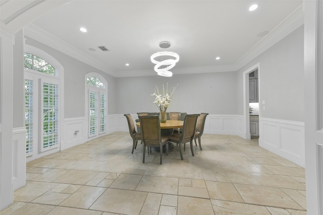 dining area featuring a chandelier and crown molding