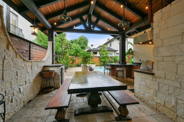 view of patio with a gazebo, an outdoor kitchen, and a bar