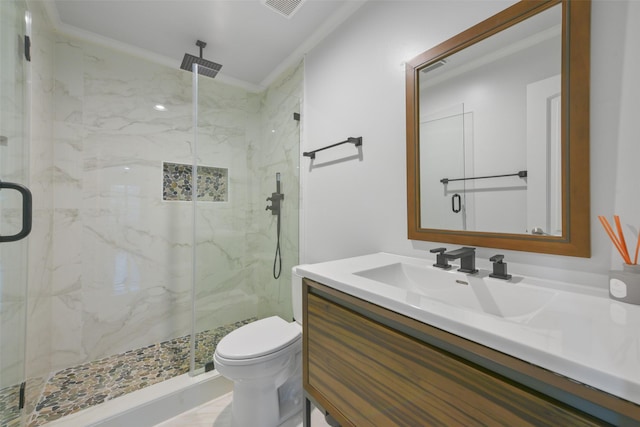 bathroom featuring toilet, vanity, an enclosed shower, and ornamental molding