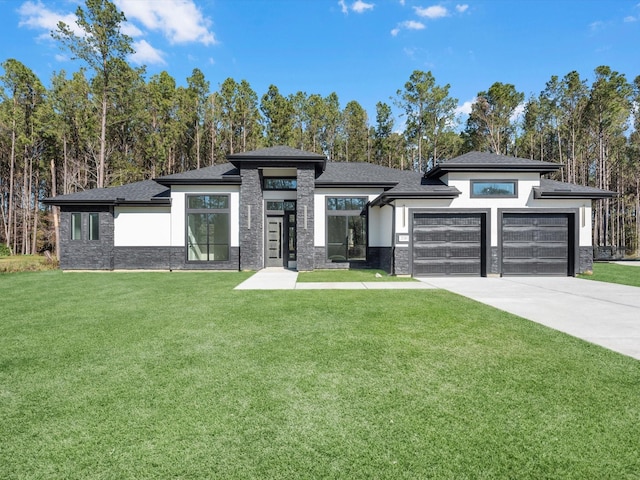 prairie-style home featuring a front yard and a garage